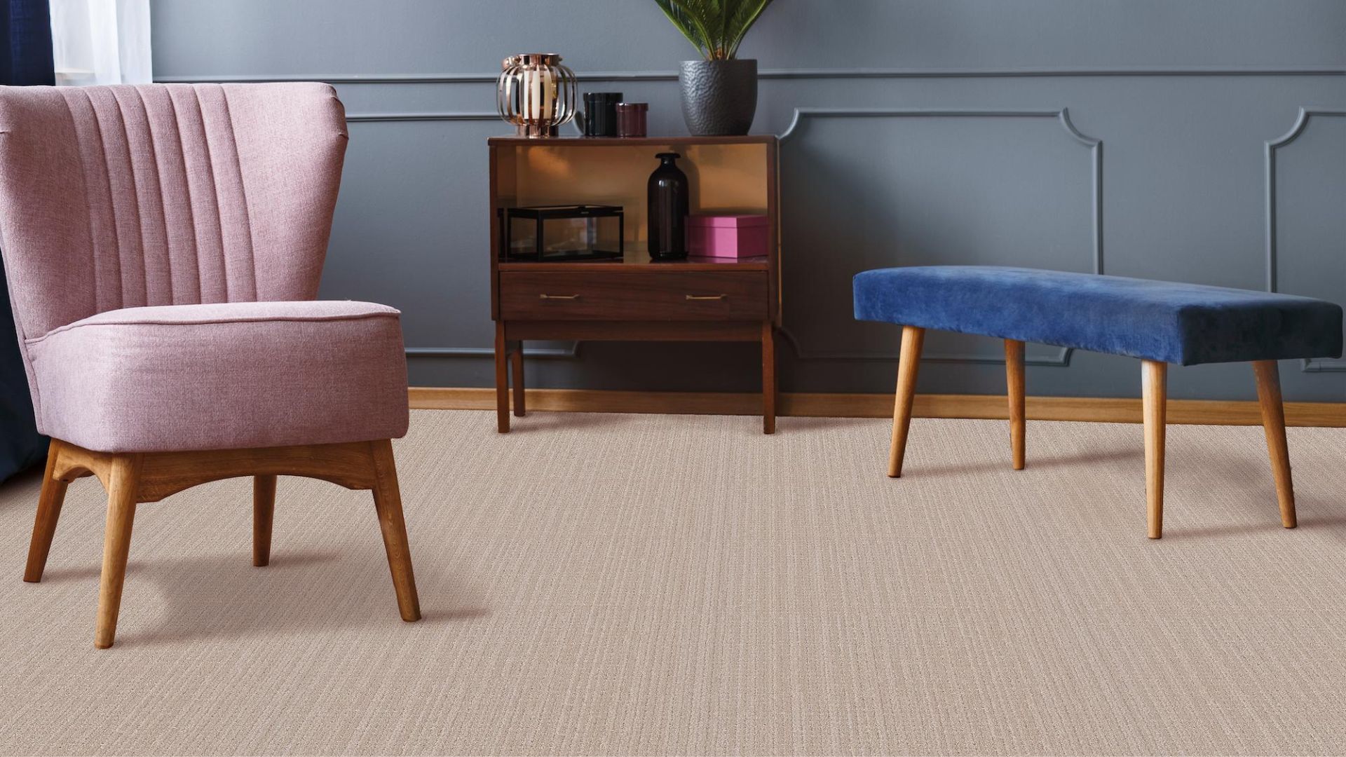 patterned beige carpets in a modern living room with pink chair and blue accent wall